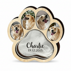 Beige paw-shaped memorial shadow box with example dog photos, a fur keepsake, name and date.